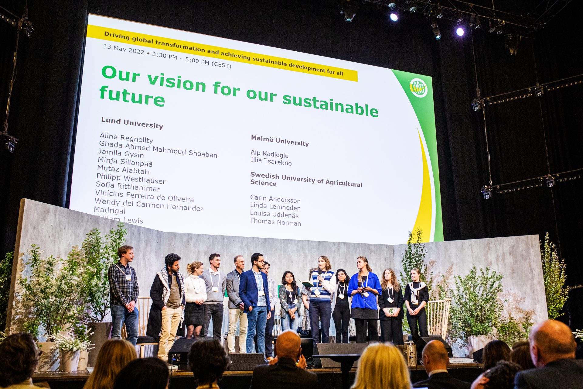 A group on stage at the ICLEI World Congress with a large sign above reading Our vision for our sustainable future, 2022.