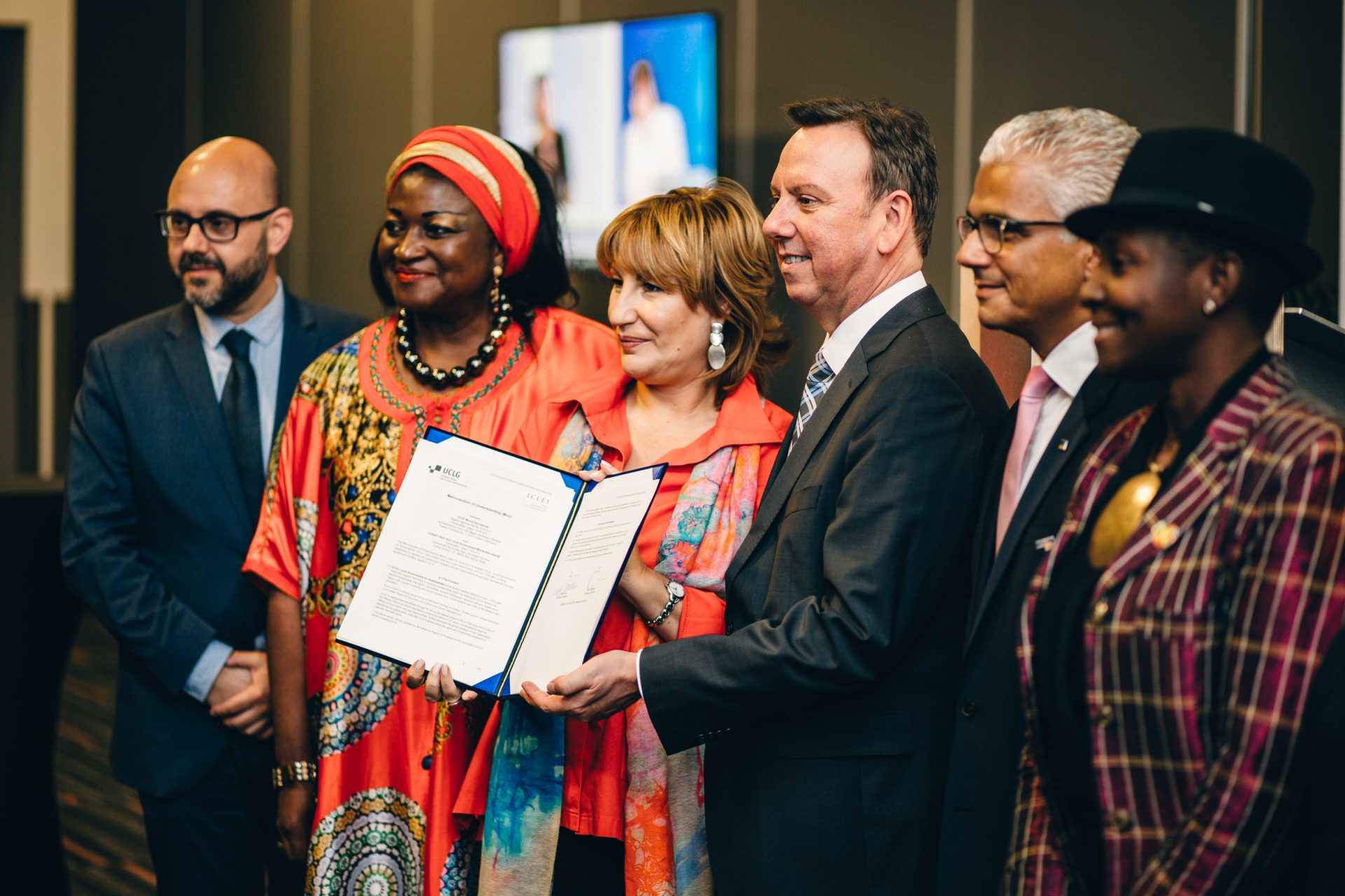 ICLEI World Congress 2018 - Day 2 - a small group of dynamic people holding an important folder and smiling for the camera.