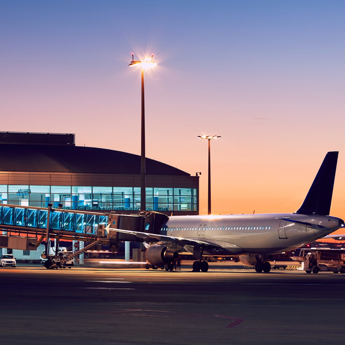 Preparation of the airplane before flight. Airport at the colorful sunset.